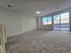 Bright living room with neutral walls, carpet, and large window to the backyard at 5817 Bonita Rose St, Las Vegas, NV 89113