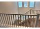 Carpeted staircase featuring a modern railing and plenty of natural light from the windows at 5817 Bonita Rose St, Las Vegas, NV 89113