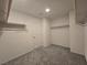 Spacious walk-in closet features carpeted floors, rods, and a door at 5817 Bonita Rose St, Las Vegas, NV 89113