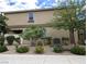 Back exterior of tan home featuring a covered patio and desert landscaping at 6168 Scarlet Leaf St, Las Vegas, NV 89148