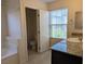 Updated bathroom featuring granite counter, tiled floors, and large soaking tub at 6168 Scarlet Leaf St, Las Vegas, NV 89148