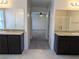 Granite countertops and double sinks complete this bathroom that leads to the primary bedroom at 6168 Scarlet Leaf St, Las Vegas, NV 89148