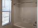 This bathroom features tiled shower and a window allowing natural light at 6168 Scarlet Leaf St, Las Vegas, NV 89148