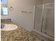This bathroom boasts granite counters, a glass shower, and a large mirror at 6168 Scarlet Leaf St, Las Vegas, NV 89148
