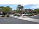 Community pool area featuring a playground and picnic tables near apartment buildings and lush landscaping at 6168 Scarlet Leaf St, Las Vegas, NV 89148