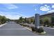 Community entrance featuring black metal gates, stone pillars, and beautifully landscaped signage at 6168 Scarlet Leaf St, Las Vegas, NV 89148