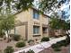 Beautiful two-story townhome with stone accents, mature trees, and low-maintenance landscaping at 6168 Scarlet Leaf St, Las Vegas, NV 89148