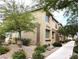 Home exterior with tan stucco, brown trim, desert landscaping and a sidewalk at 6168 Scarlet Leaf St, Las Vegas, NV 89148