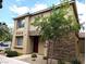 Two-story home featuring tan stucco, stone accents, and a desert landscaped yard at 6168 Scarlet Leaf St, Las Vegas, NV 89148