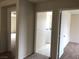 Hallway with views into rooms featuring neutral walls and carpet and tile flooring at 6168 Scarlet Leaf St, Las Vegas, NV 89148