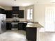 Kitchen features stainless steel appliances, granite countertops, and dark cabinets at 6168 Scarlet Leaf St, Las Vegas, NV 89148