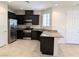 Modern kitchen featuring stainless steel appliances, dark wood cabinets, and granite countertops at 6168 Scarlet Leaf St, Las Vegas, NV 89148