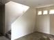 Unfurnished living room with tile flooring, staircase, and bright natural light at 6168 Scarlet Leaf St, Las Vegas, NV 89148