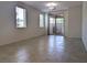 Spacious living room with tile flooring, natural light, and a sliding glass door to the outdoor patio at 6168 Scarlet Leaf St, Las Vegas, NV 89148