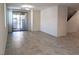 Bright living room with tile floors, access to the patio, and staircase to the upper level at 6168 Scarlet Leaf St, Las Vegas, NV 89148