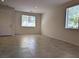Bright living room with neutral tile flooring, recessed lighting, and large windows for ample natural light at 6168 Scarlet Leaf St, Las Vegas, NV 89148