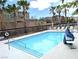 Sparkling community pool with lounge chairs and palm trees at 6168 Scarlet Leaf St, Las Vegas, NV 89148