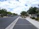 Street view featuring new homes, mature landscaping and access to community features at 6168 Scarlet Leaf St, Las Vegas, NV 89148