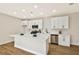 Contemporary kitchen with white cabinetry, stainless steel appliances, quartz countertops, and hardwood-style floors at 6388 Canyon Dawn Ave, Las Vegas, NV 89108