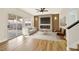 Cozy living room features a modern fireplace, flat screen TV, sliding glass door to patio, and hardwood style floors at 6388 Canyon Dawn Ave, Las Vegas, NV 89108