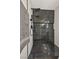 Close up of modern shower with black marble tiling and updated shower head at 6388 Canyon Dawn Ave, Las Vegas, NV 89108