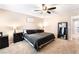 Neutral Primary bedroom features a ceiling fan and a plush bed with black bedding at 6650 Drusilla St, North Las Vegas, NV 89084