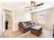 A bedroom with a comfortable sofa, an ottoman, and cozy carpeting at 6650 Drusilla St, North Las Vegas, NV 89084