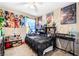 Bedroom decorated with colorful posters, toys, and a black bed at 6650 Drusilla St, North Las Vegas, NV 89084