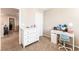 Bedroom featuring a white dresser and a white desk with a turquoise chair at 6650 Drusilla St, North Las Vegas, NV 89084