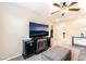 Upstairs living area with a ceiling fan and a modern entertainment center at 6650 Drusilla St, North Las Vegas, NV 89084