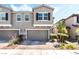 Charming townhome featuring a 2-car garage and a well-maintained front yard with lush landscaping at 6650 Drusilla St, North Las Vegas, NV 89084