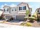 Attractive townhome with a two-car garage and manicured front yard landscaping at 6650 Drusilla St, North Las Vegas, NV 89084