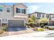 Inviting two-story townhome featuring a paved driveway and well-maintained landscaping at 6650 Drusilla St, North Las Vegas, NV 89084