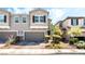 Attractive townhome with a two-car garage and manicured front yard landscaping at 6650 Drusilla St, North Las Vegas, NV 89084