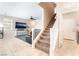 Open living area with tile flooring, stairway, and view into carpeted living room at 6650 Drusilla St, North Las Vegas, NV 89084