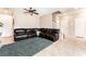 Cozy living room with a sectional sofa, tile flooring, and stairs to the second floor at 6650 Drusilla St, North Las Vegas, NV 89084