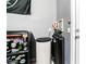 Functional utility room featuring black and gray colored equipment next to a door and a Raider's themed fridge at 6650 Drusilla St, North Las Vegas, NV 89084