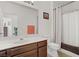 Well-lit bathroom with a vanity, mirror, and shower featuring modern fixtures and a neutral color scheme at 7119 S Durango Dr # 303, Las Vegas, NV 89113