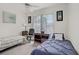 Bright bedroom with two twin beds, desk, ceiling fan, and ample natural light from the window at 7119 S Durango Dr # 303, Las Vegas, NV 89113