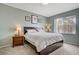 Comfortable bedroom with a bed featuring built-in storage, a large window, and stylish bedside tables at 7119 S Durango Dr # 303, Las Vegas, NV 89113