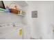 Functional laundry room featuring white washer and dryer with overhead shelving for storage at 7119 S Durango Dr # 303, Las Vegas, NV 89113
