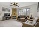 Cozy living room with a fireplace, flatscreen TV, ceiling fan, neutral paint, and plush sofas at 7119 S Durango Dr # 303, Las Vegas, NV 89113