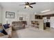 Open floorplan with a living room, bar seating, a dining area, and an open kitchen with dark cabinetry at 7119 S Durango Dr # 303, Las Vegas, NV 89113