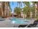 Inviting swimming pool surrounded by lounge chairs and mature palm trees, creating a relaxing atmosphere at 7119 S Durango Dr # 303, Las Vegas, NV 89113