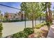 Well-maintained tennis court enclosed by a fence and lush landscaping provides a recreational amenity for residents at 7119 S Durango Dr # 303, Las Vegas, NV 89113