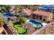 Aerial view of a home showcasing a pool, putting green, tennis court and outdoor entertaining spaces at 7470 Eldora Av, Las Vegas, NV 89117