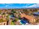 Aerial view showcasing the home's pool, putting green, tennis court, and proximity to the Las Vegas skyline at 7470 Eldora Av, Las Vegas, NV 89117