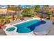 Aerial view of a pristine backyard with in-ground pool, hot tub and putting green at 7470 Eldora Av, Las Vegas, NV 89117