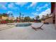 Inviting backyard featuring a pool, jacuzzi, hammock, and lounge seating for ultimate relaxation at 7470 Eldora Av, Las Vegas, NV 89117