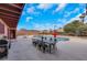 This backyard features an in-ground pool, outdoor dining and mature trees for shade at 7470 Eldora Av, Las Vegas, NV 89117